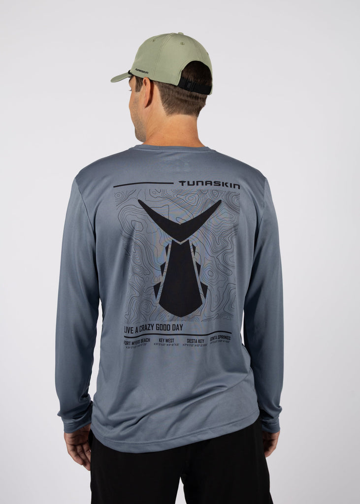 model wearing long sleeve charcoal shirt with tunaskin topo map design on the back
