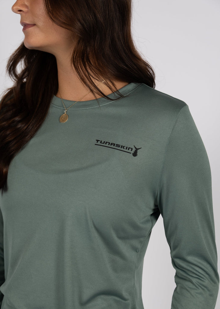 model wearing a women's long sleeve olive with left chest tunaskin logo