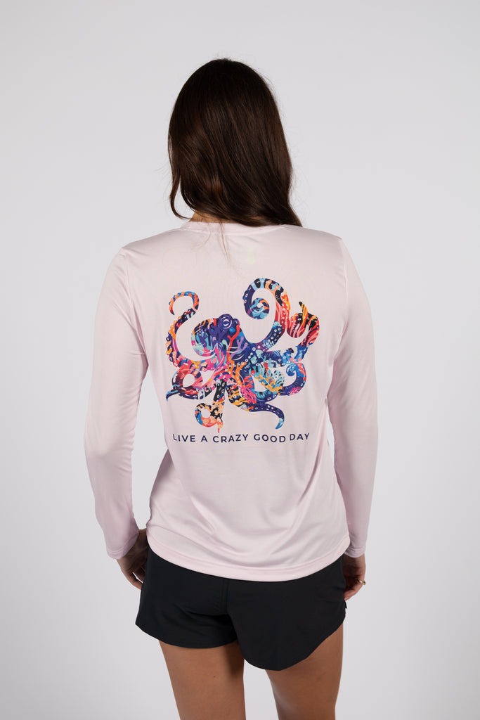 female model wearing TSK-WLSE-51-FLMGDS-01 flamingo long sleeve shirt with octopus illustration on the back