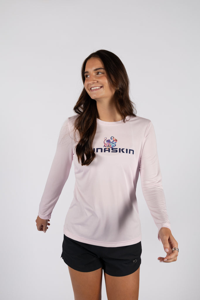 Model wearing TSK-WLSE-51-FLMGDS-01 long sleeve shirt in flamingo pink with tunaskin logo on front