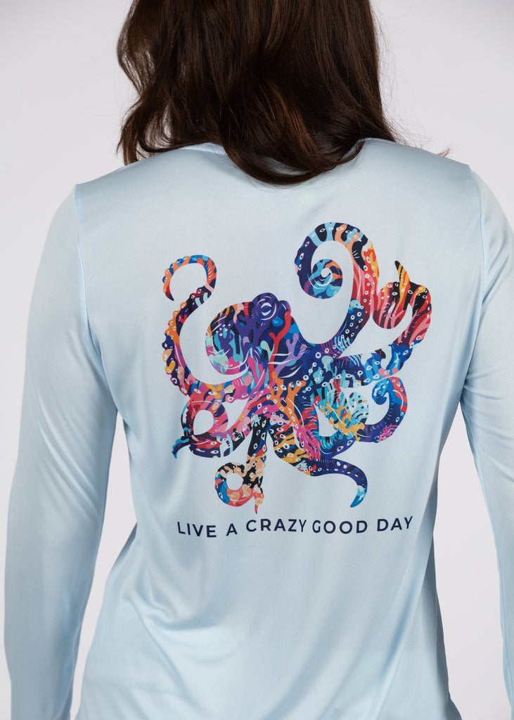 Light blue long-sleeve shirt with a colorful octopus design and text on the back, worn by a person.