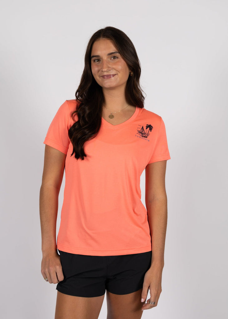 Model wearing coral v-neck with left chest tunaskin logo