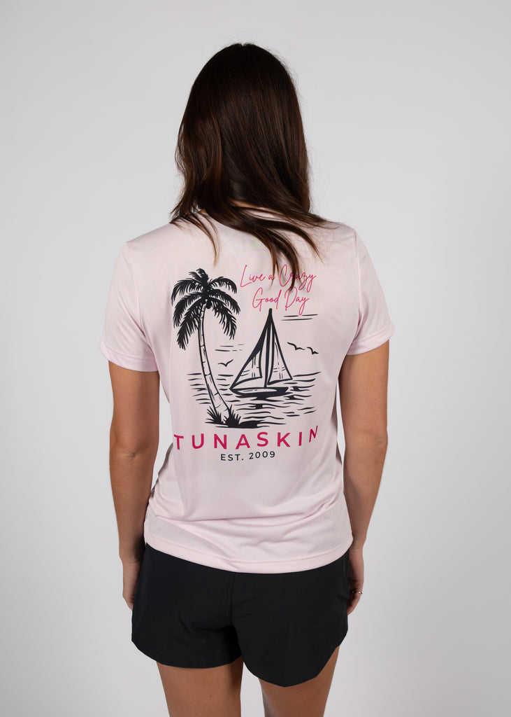 model wearing women's v-neck showing the back design with a sailboat