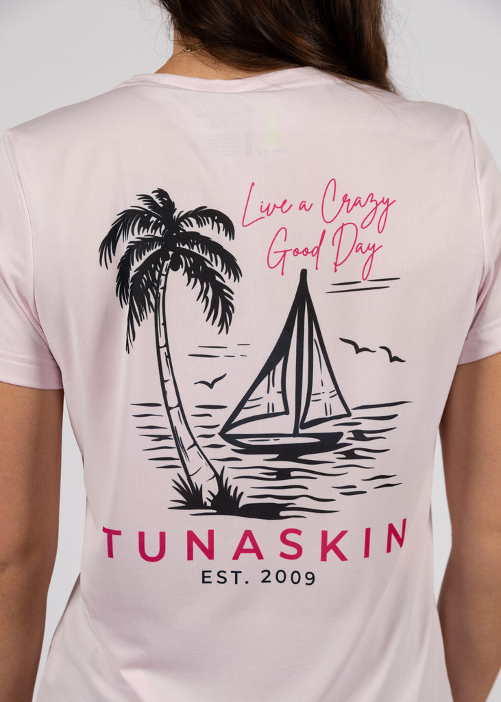 Pink t-shirt with a palm tree, sailboat, and 'Tunaskin' branding on the back.