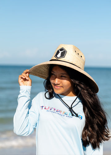 girl wearing youth tunaskin long sleeve shirt with straw hat