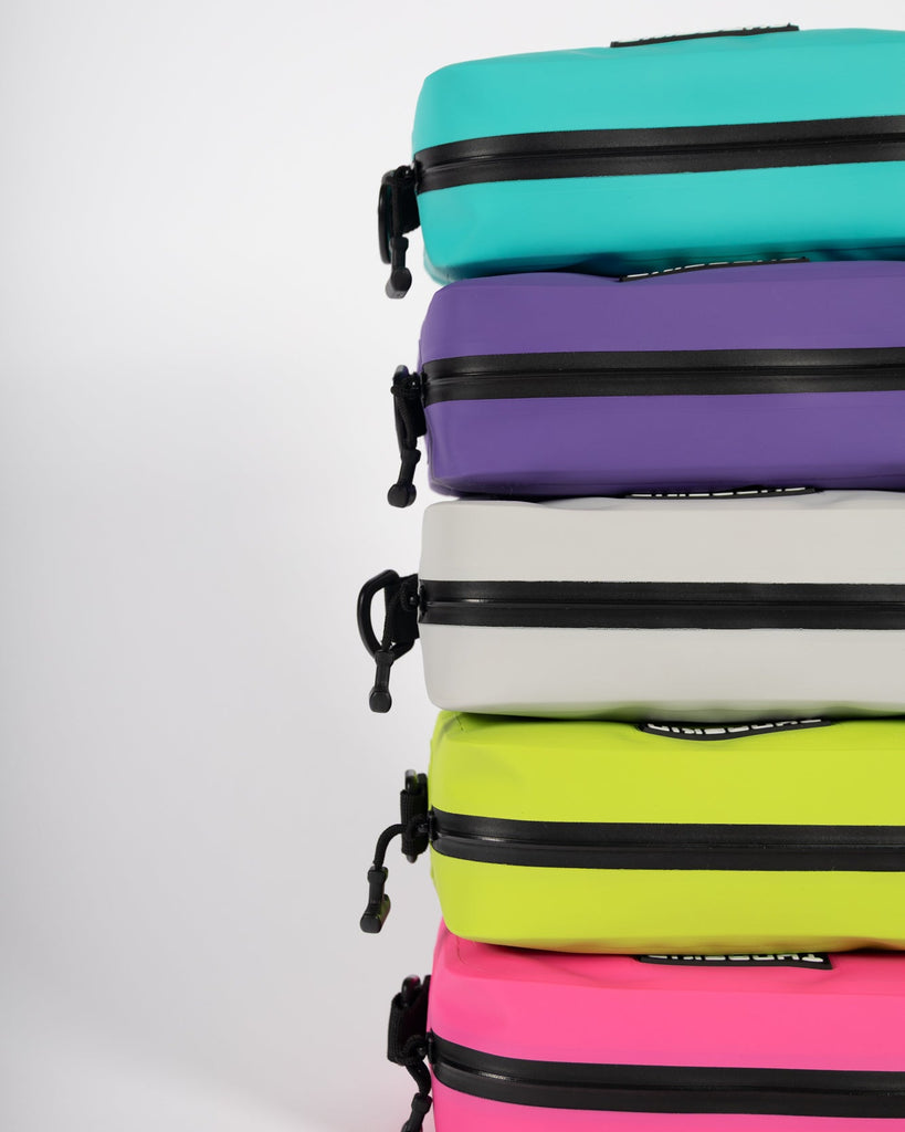 Stack of colorfulTunaskin board bags with zippers on a white background