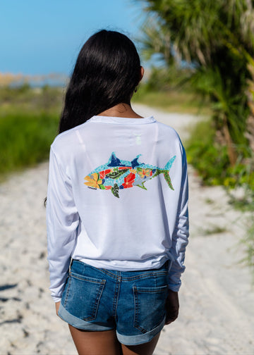 girl wearing white tunaskin long sleeve with colorful tuna illustration on the back
